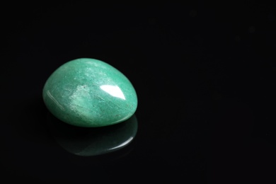 Beautiful aventurine gemstone on black background. Space for text