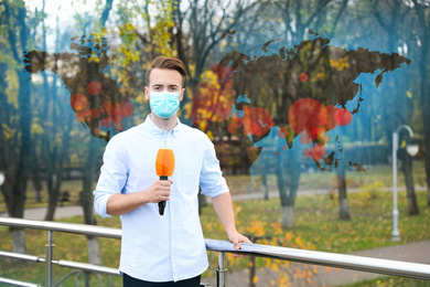 Image of Journalist with medical mask presenting news during coronavirus outbreak. World map demonstrating spread of disease