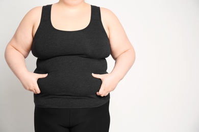 Photo of Overweight woman on light background