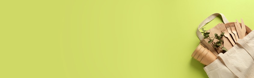 Image of Flat lay composition with eco friendly products on light green background, space for text. Banner design