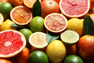 Photo of Different citrus fruits as background, closeup. Healthy diet