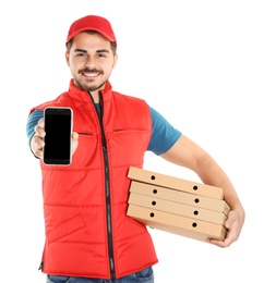 Photo of Young man holding pizza boxes and smartphone isolated on white, mockup for design. Online food delivery