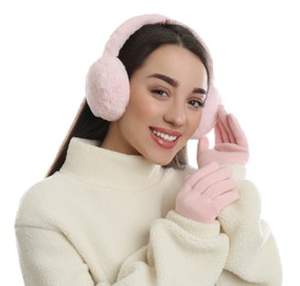 Photo of Beautiful young woman wearing earmuffs on white background