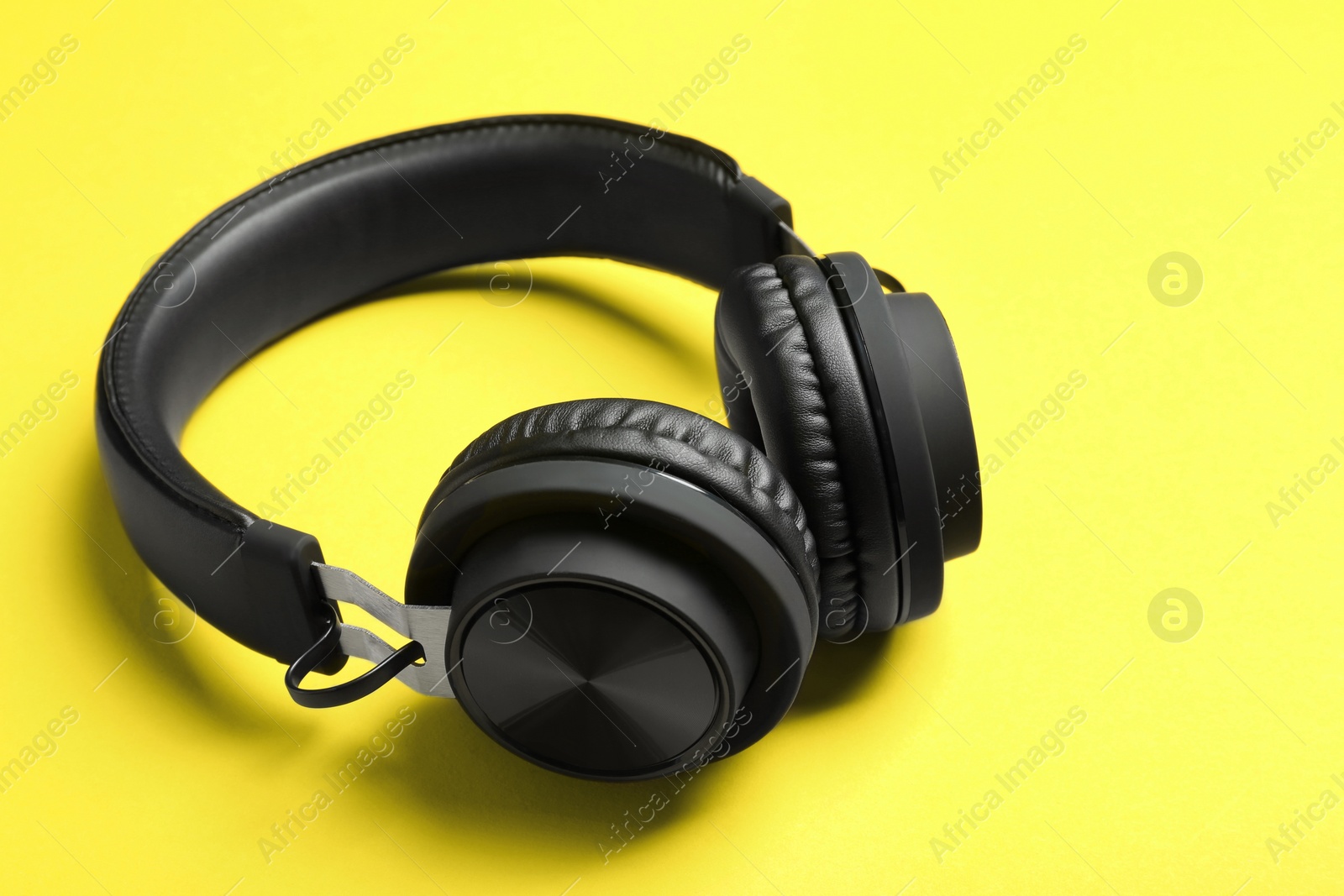 Photo of Stylish headphones with pads on color background