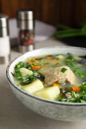 Photo of Delicious sorrel soup with meat served on table, closeup