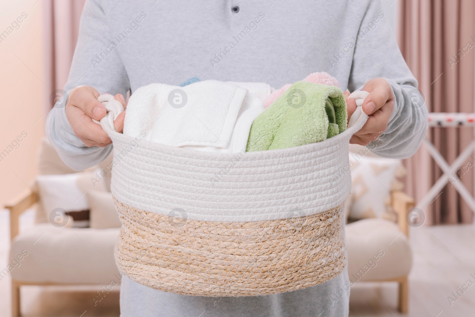 Photo of Man with basket full of laundry at home, closeup