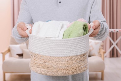 Photo of Man with basket full of laundry at home, closeup