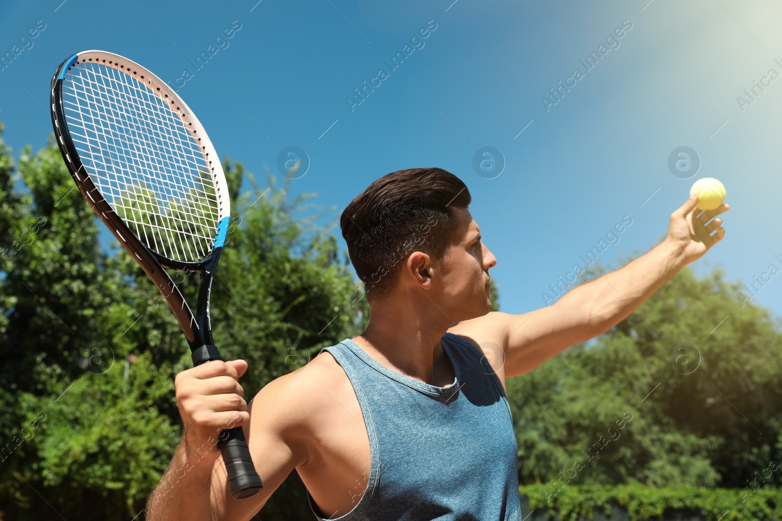 Photo of Man playing tennis in park during sunny day