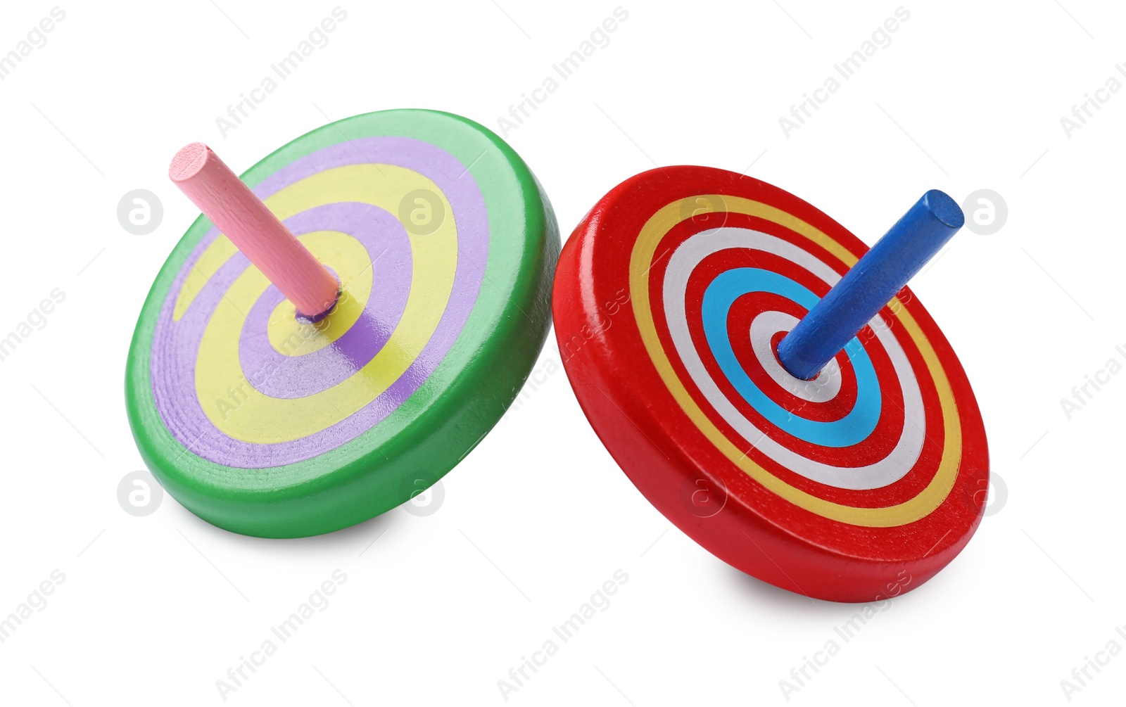 Photo of Two bright spinning tops isolated on white