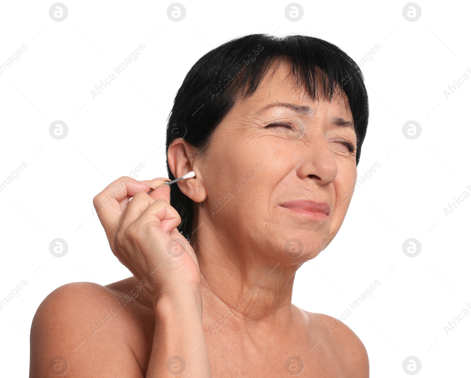 Photo of Senior woman cleaning ear with cotton swab on white background