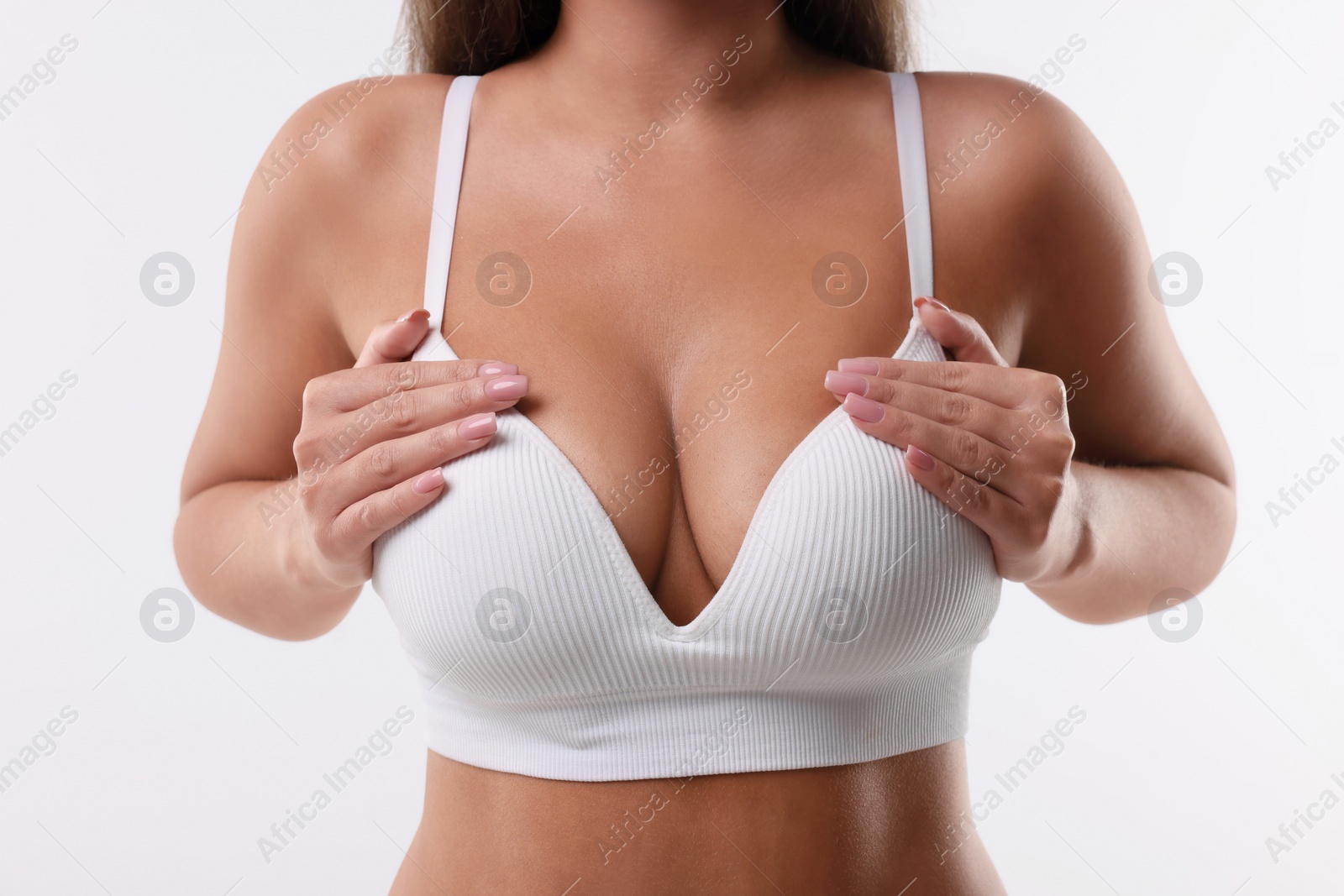 Photo of Woman with beautiful breast on white background, closeup