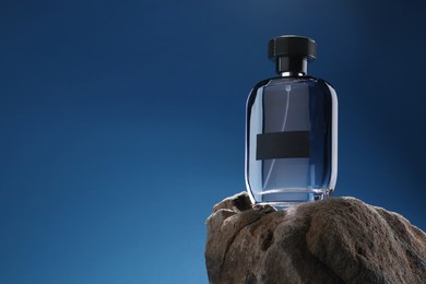 Stylish presentation of luxury men`s perfume on stone against light blue background. Space for text