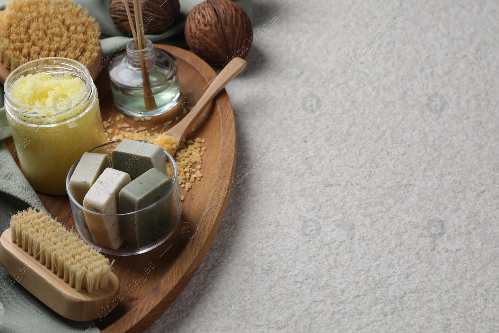 Photo of Composition with different spa products and reed air freshener on light grey textured table. Space for text