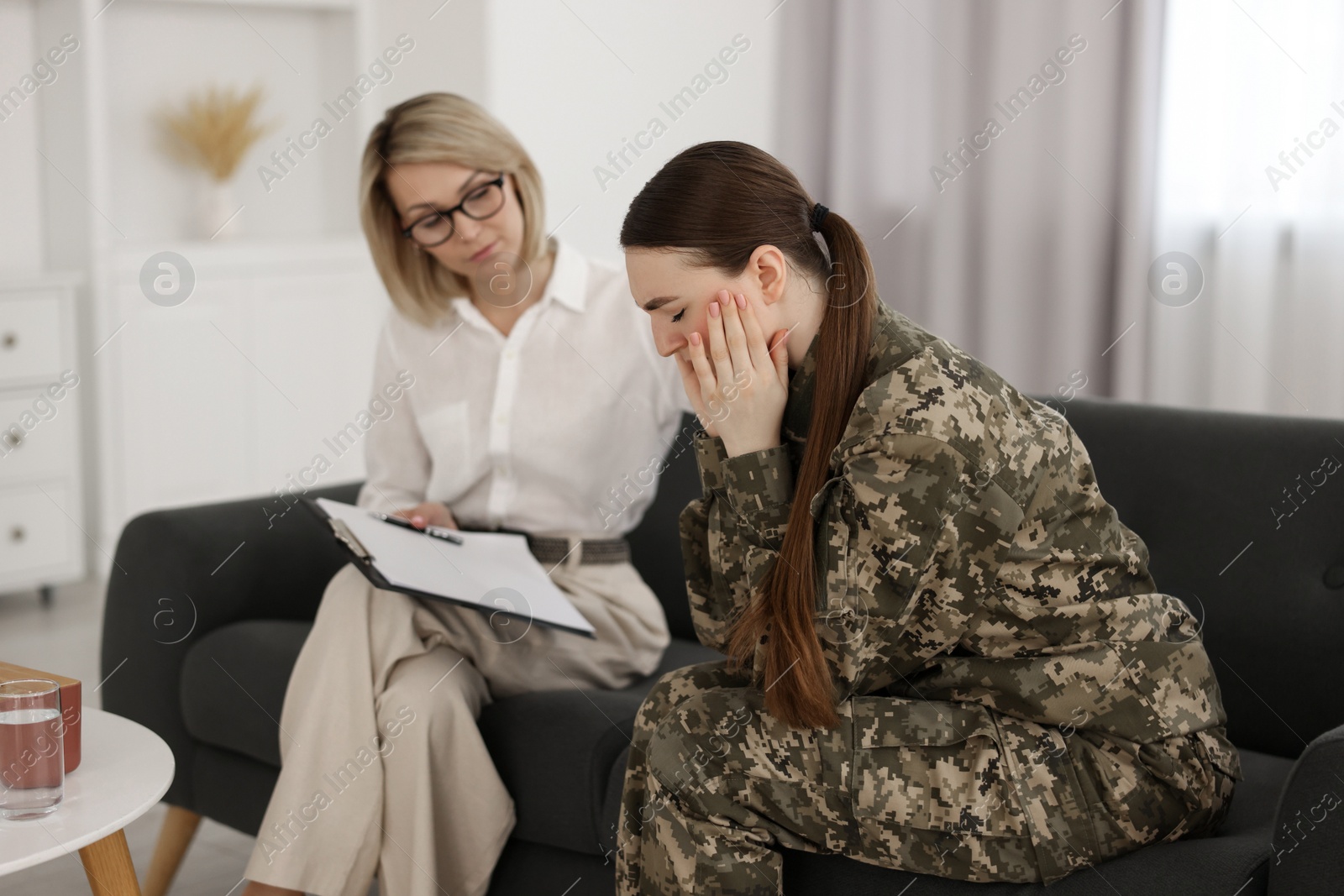 Photo of Psychotherapist working with military woman in office