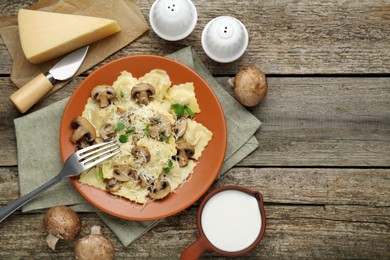 Photo of Delicious ravioli with ingredients on wooden table, flat lay. Space for text