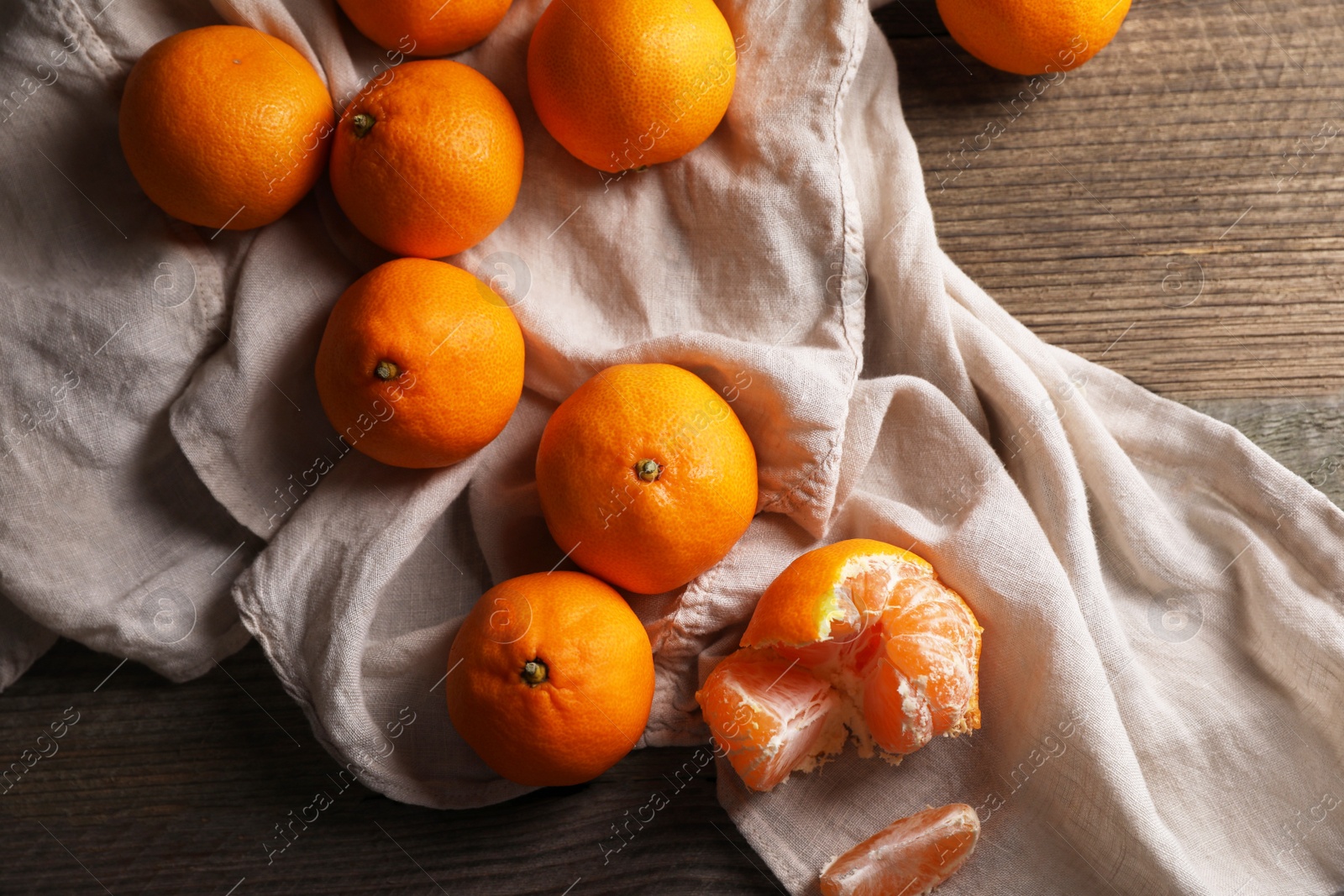 Photo of Tasty fresh tangerines on wooden table, flat lay