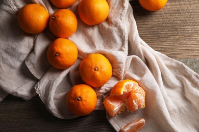 Tasty fresh tangerines on wooden table, flat lay