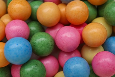 Photo of Many bright chewy gumballs as background, top view