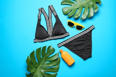 Photo of Flat lay composition with bikini and beach objects on color background