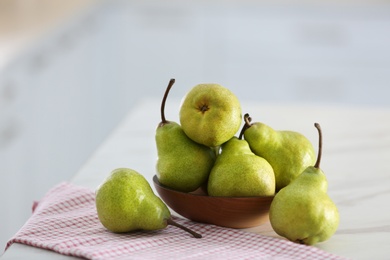 Photo of Bowl with fresh ripe pears on white table