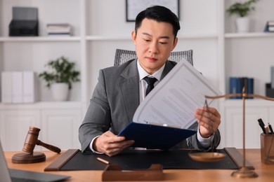 Notary working at wooden table in office