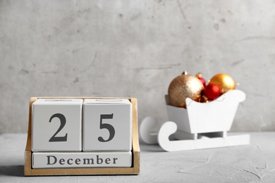 Photo of Wooden block calendar and decor on table. Christmas countdown