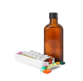Bottle of syrup with pills on white background. Cough and cold medicine