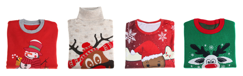 Image of Set of folded Christmas sweaters on white background. Banner design