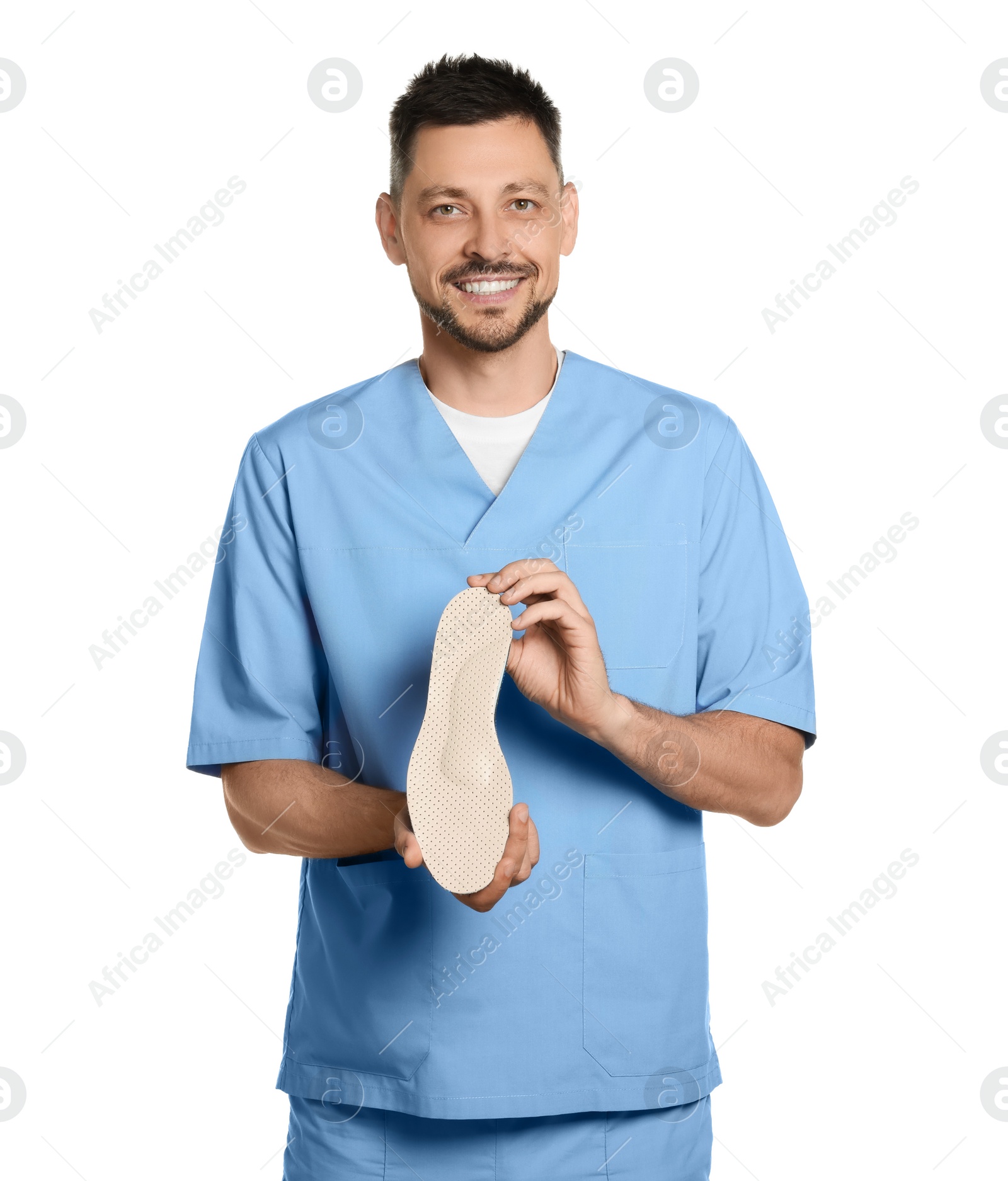 Photo of Handsome male orthopedist showing insole on white background