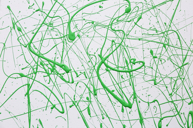 Photo of Green paint splashes on white canvas as background. Art and creativity