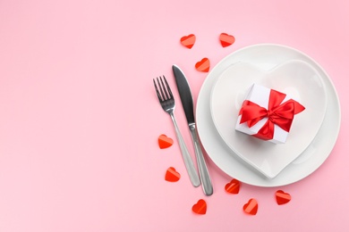 Photo of Beautiful table setting on pink background, flat lay with space for text. Valentine's Day dinner