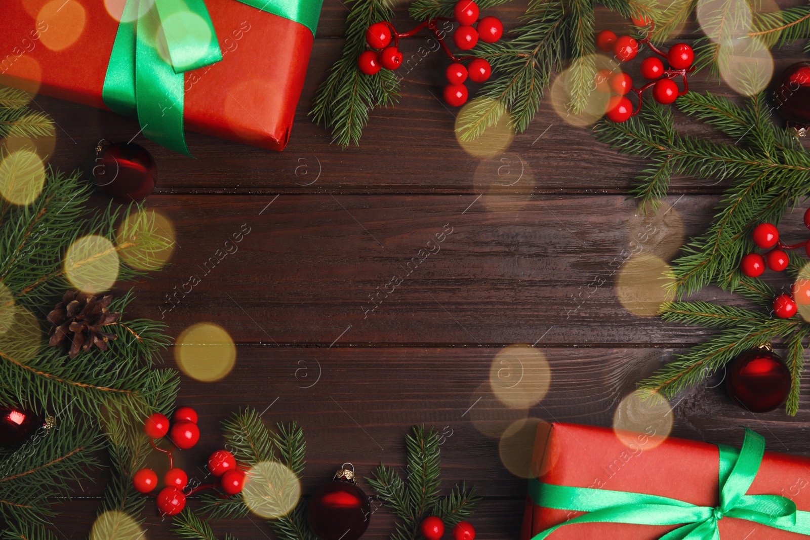 Photo of Frame made with gift boxes and Christmas decor on wooden table, flat lay. Space for text