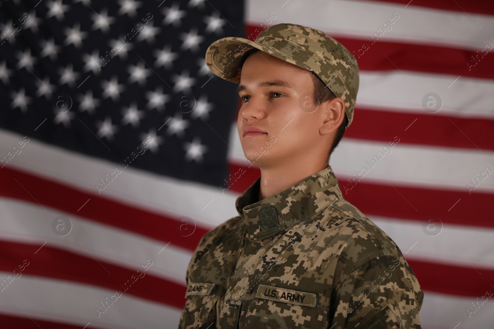 Photo of Male soldier and American flag on background. Military service