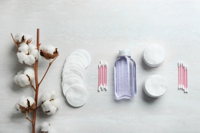 Flat lay composition with cotton hygienic products on light background