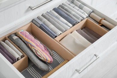 Photo of Open drawer with different textiles in kitchen, above view