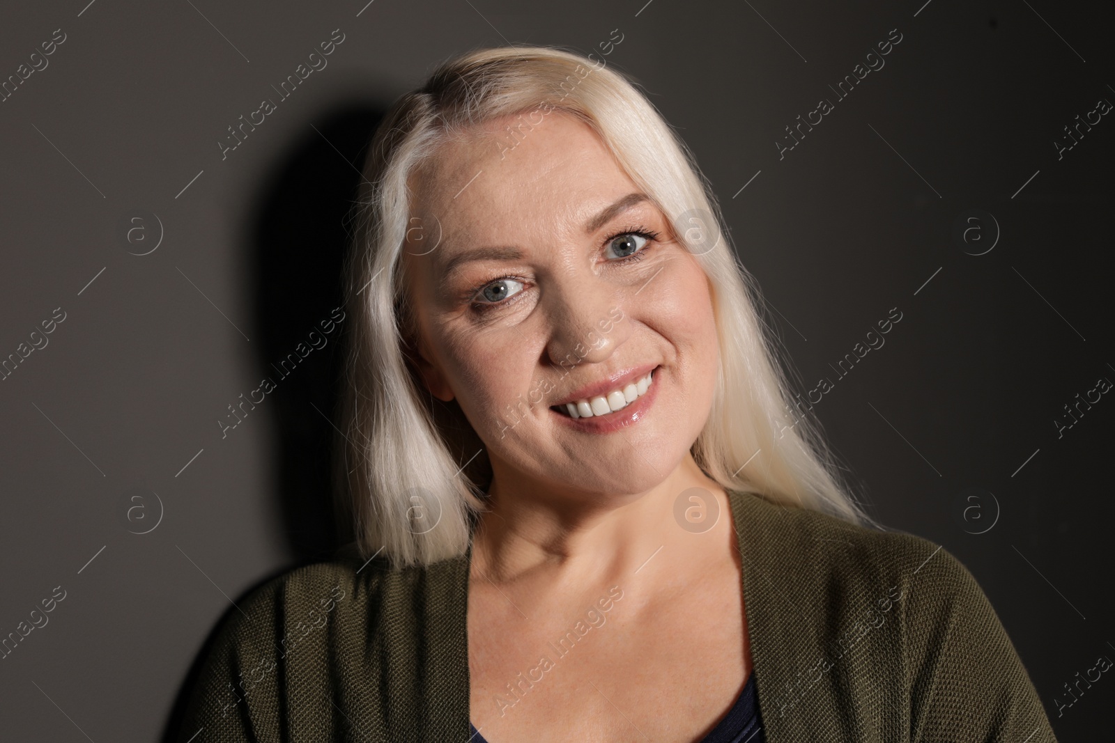 Photo of Portrait of mature woman on black background