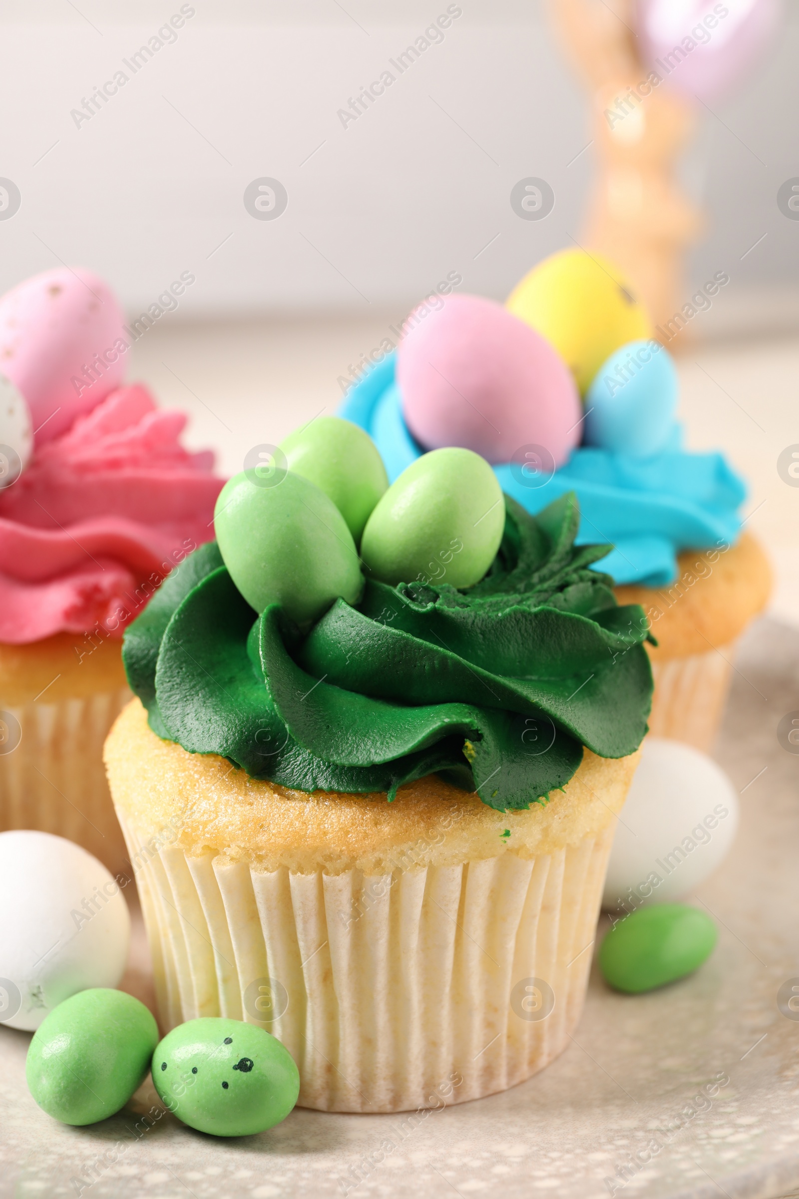 Photo of Tasty cupcakes with Easter decor on table, closeup