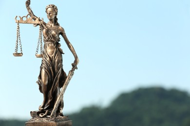 Photo of Figure of Lady Justice against sky, space for text. Symbol of fair treatment under law