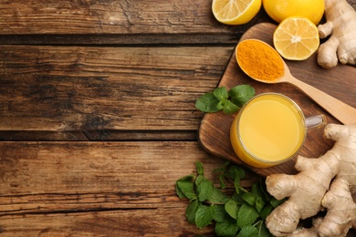 Flat lay composition with immunity boosting drink on wooden table. Space for text