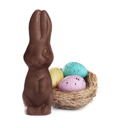 Photo of Chocolate Easter bunny and eggs on white background