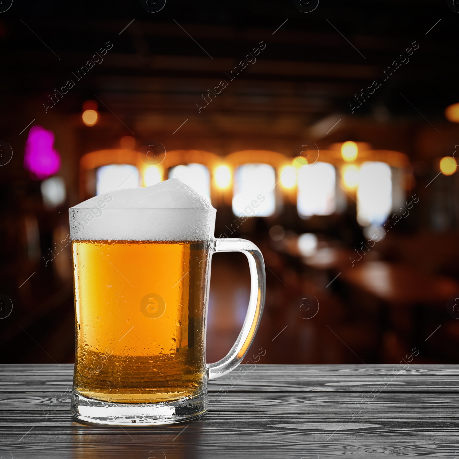 Image of Fresh cold beer on wooden table in pub