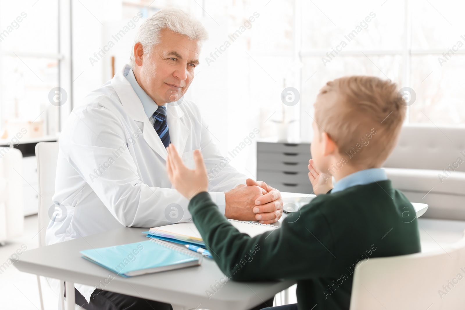 Photo of Little boy having appointment at child psychologist office