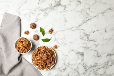 Photo of Flat lay composition with walnuts and space for text on marble background