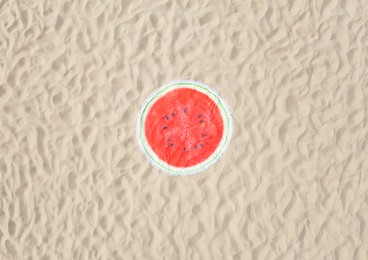 Round watermelon beach towel on sand, aerial view