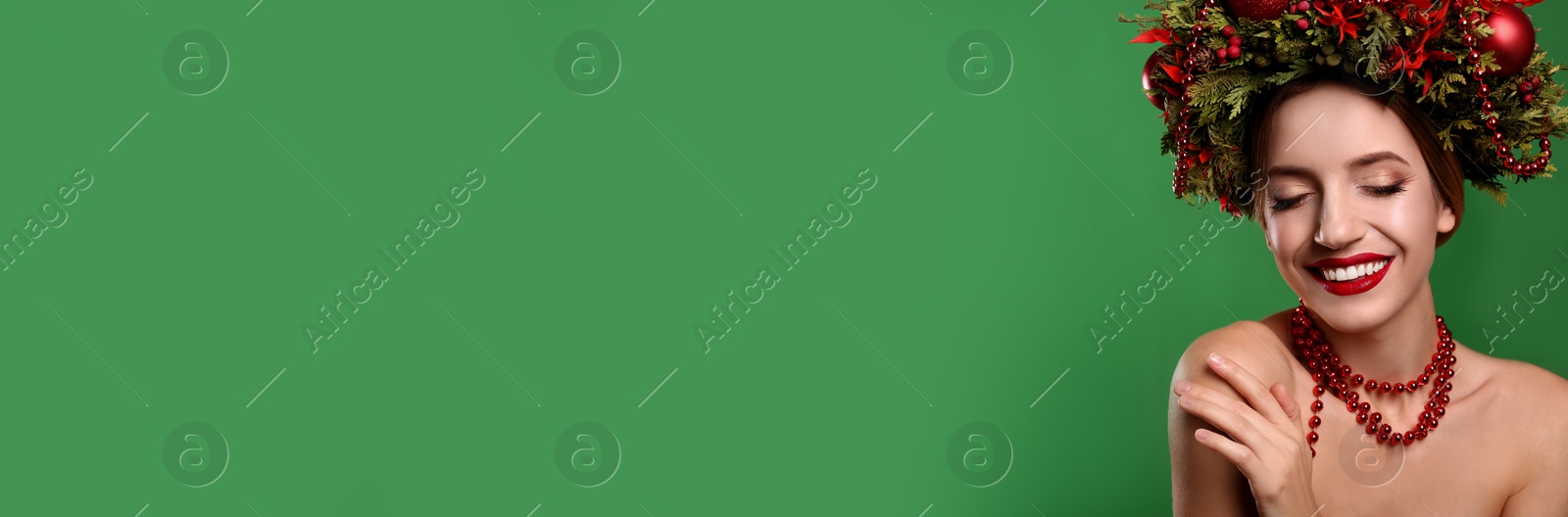 Image of Beautiful young woman wearing Christmas wreath on green background, space for text. Banner design 