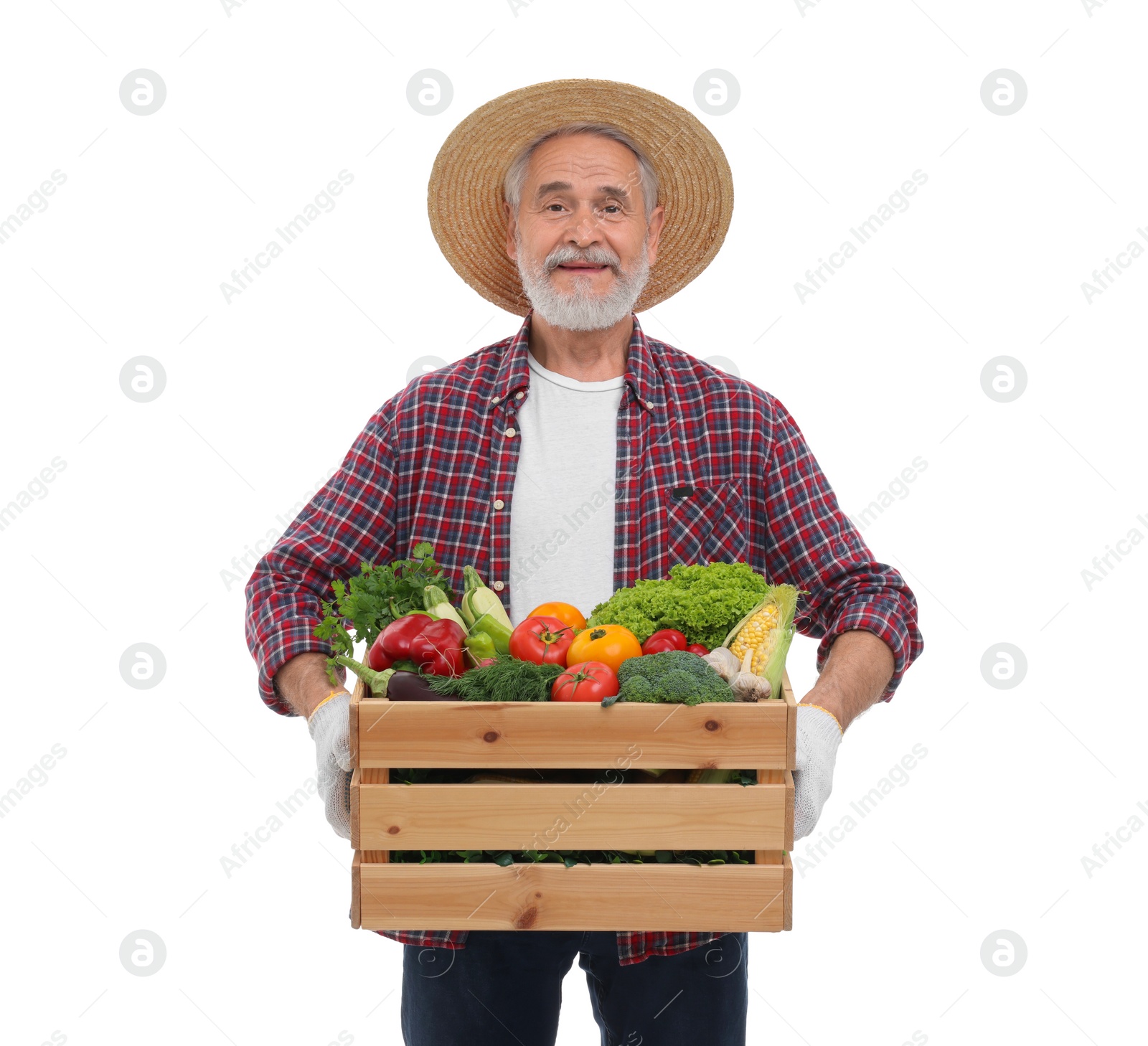 Photo of Harvesting season. Happy farmer holding wooden crate with vegetables on white background