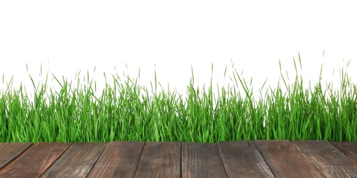 Wooden deck and green grass isolated on white