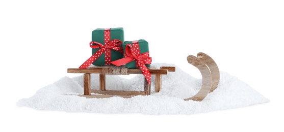 Photo of Wooden sleigh with gift boxes on white background. Christmas holiday decor