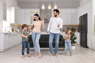 Happy family dancing and having fun at home