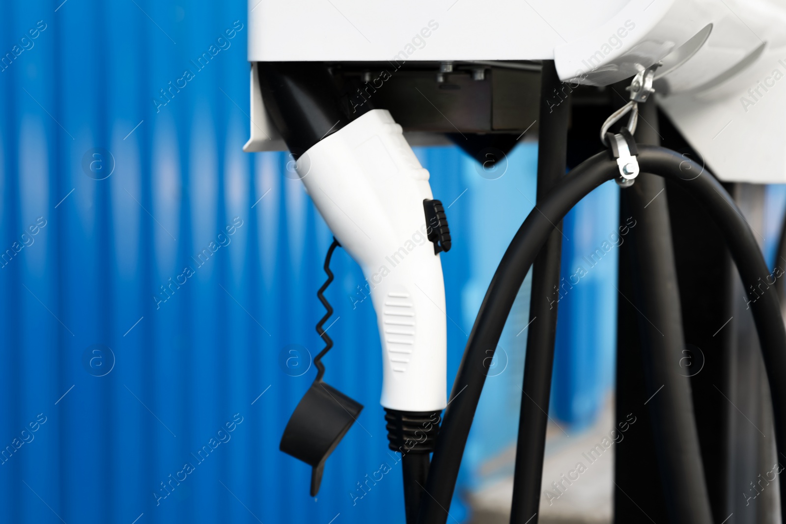 Photo of Electric vehicle charging station outdoors, closeup view